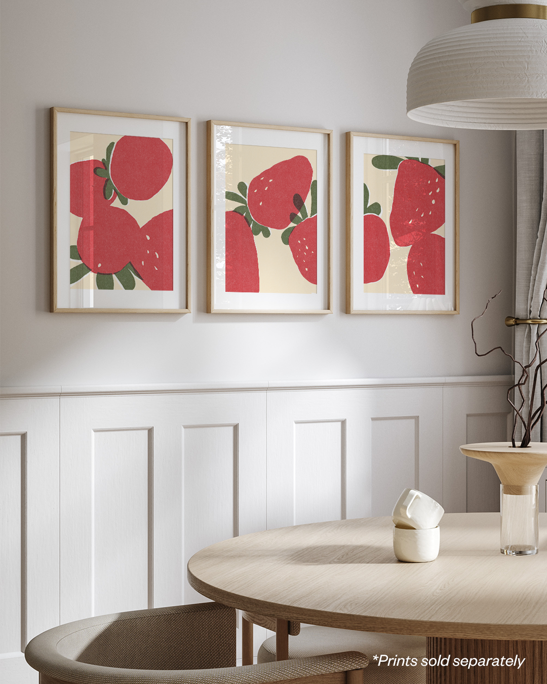 Framed strawberry prints styled in a bright living room gallery wall